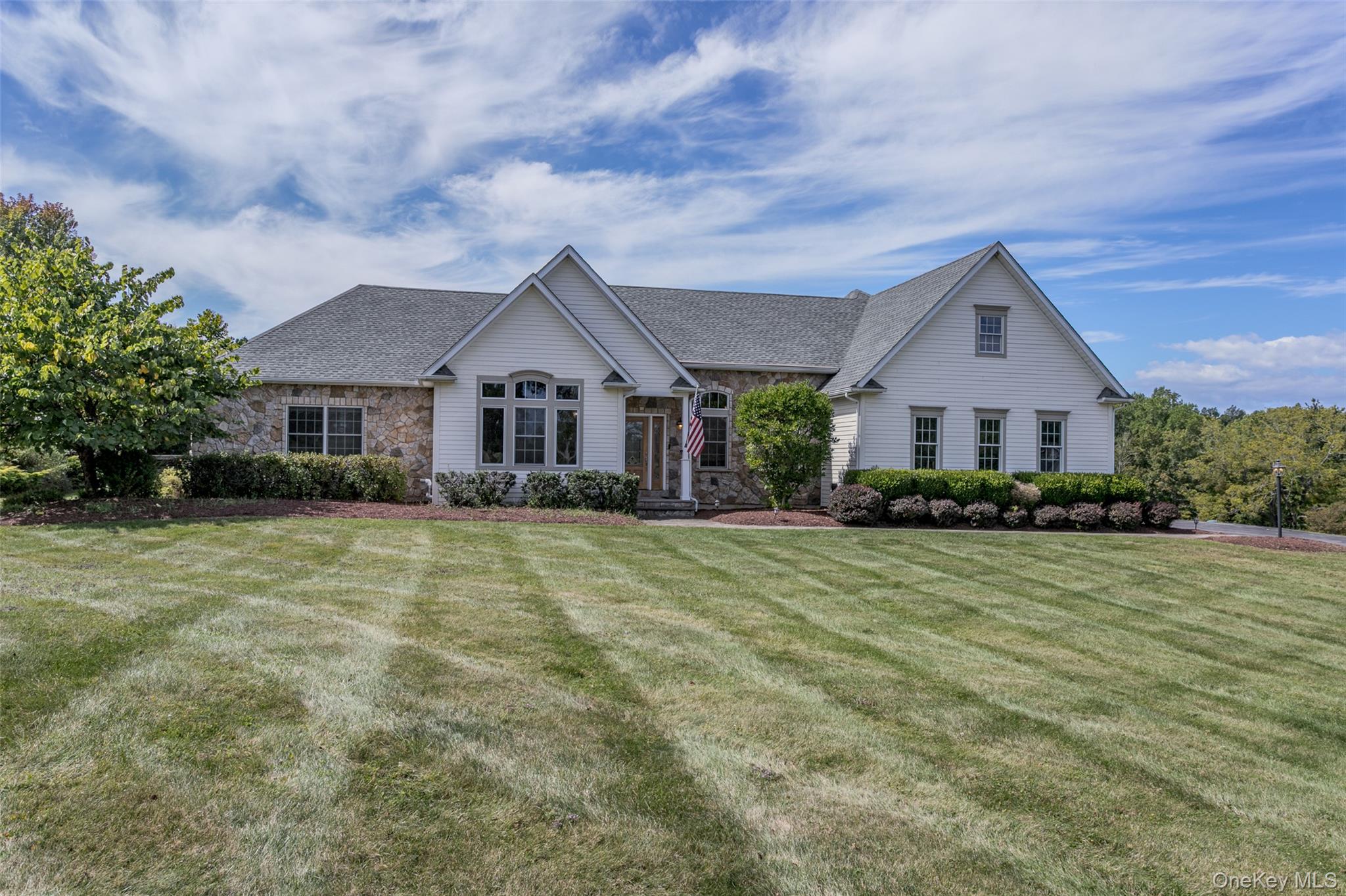 a front view of a house with a garden