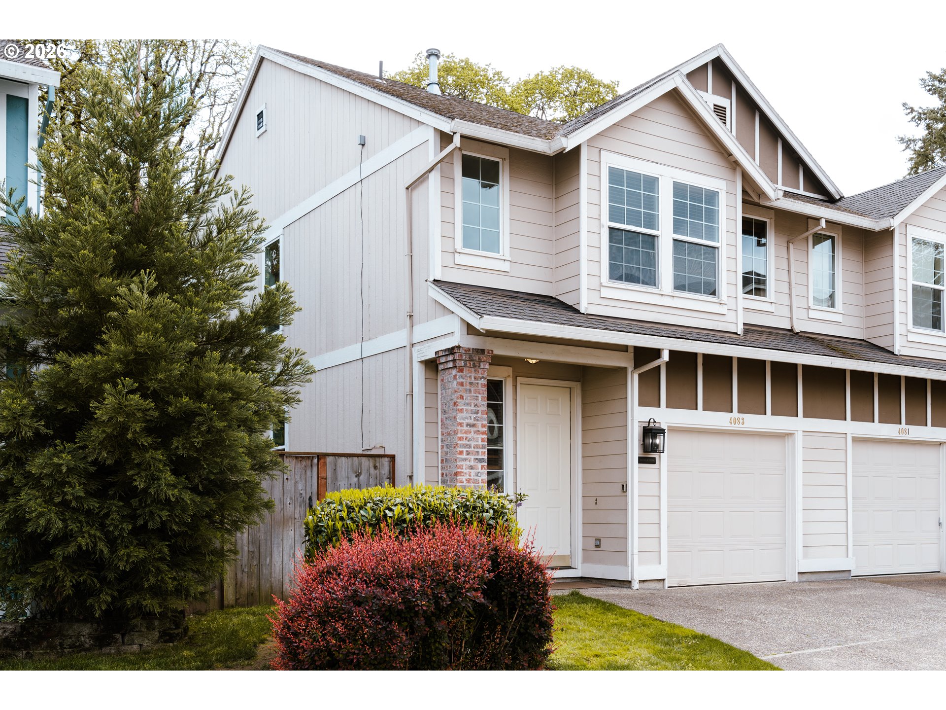 4083 Southwest 182nd Place Beaverton, OR 97078 - Photo 23 of 27 a view of a white house next to a yard