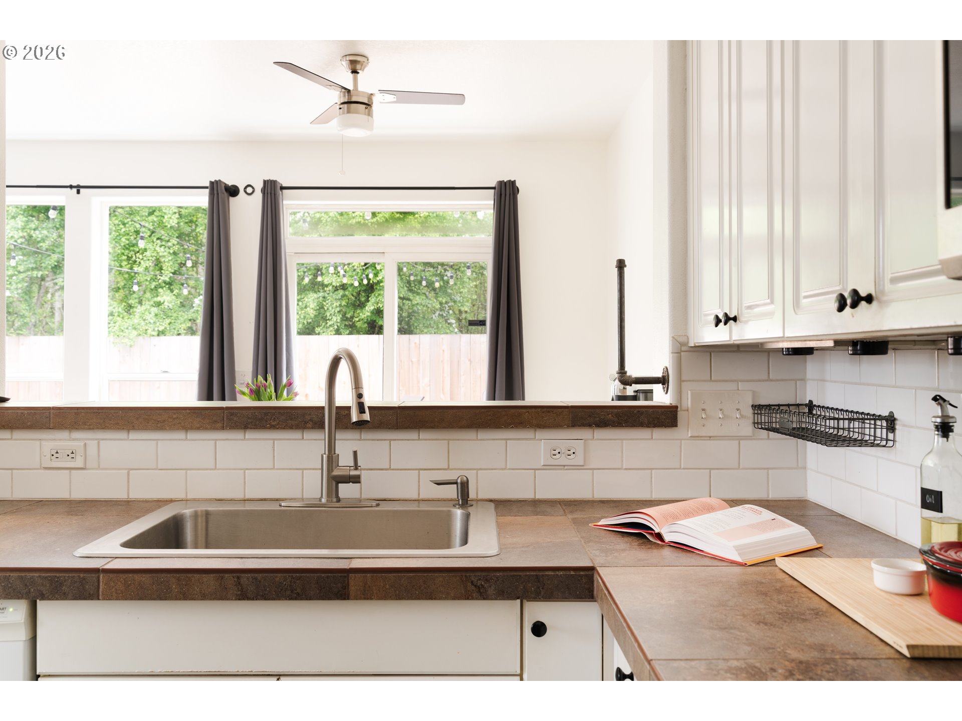 4083 Southwest 182nd Place Beaverton, OR 97078 - Photo 8 of 27 a kitchen with a sink a counter top space and cabinets