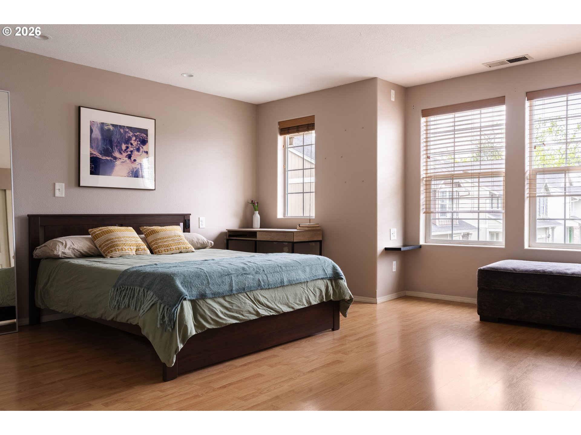 4083 Southwest 182nd Place Beaverton, OR 97078 - Photo 10 of 27 a spacious bedroom with a bed a couch and a large window