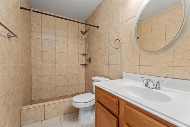 an empty room with windows and ceiling fan