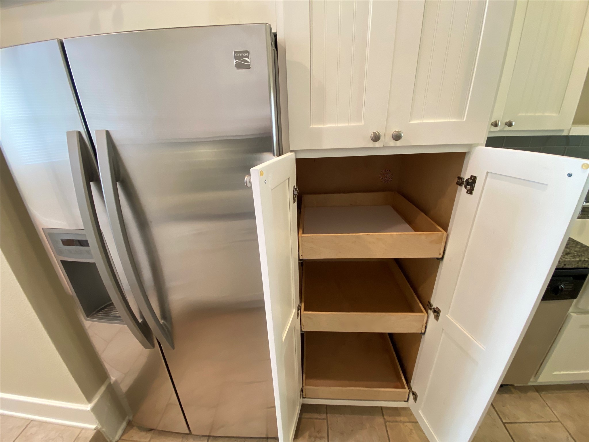 735 Arlington Street, Unit 3 Houston, TX 77007 - Photo 11 of 32 Pull-out shelving in the second cabinet, ideal for pantry use.