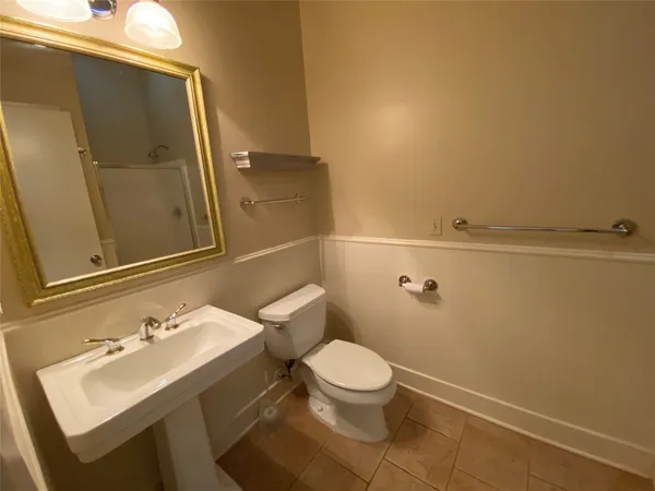 a bathroom with a sink a toilet and mirror