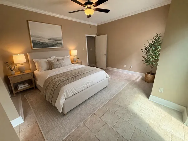 a bedroom with a bed and a painting on the wall