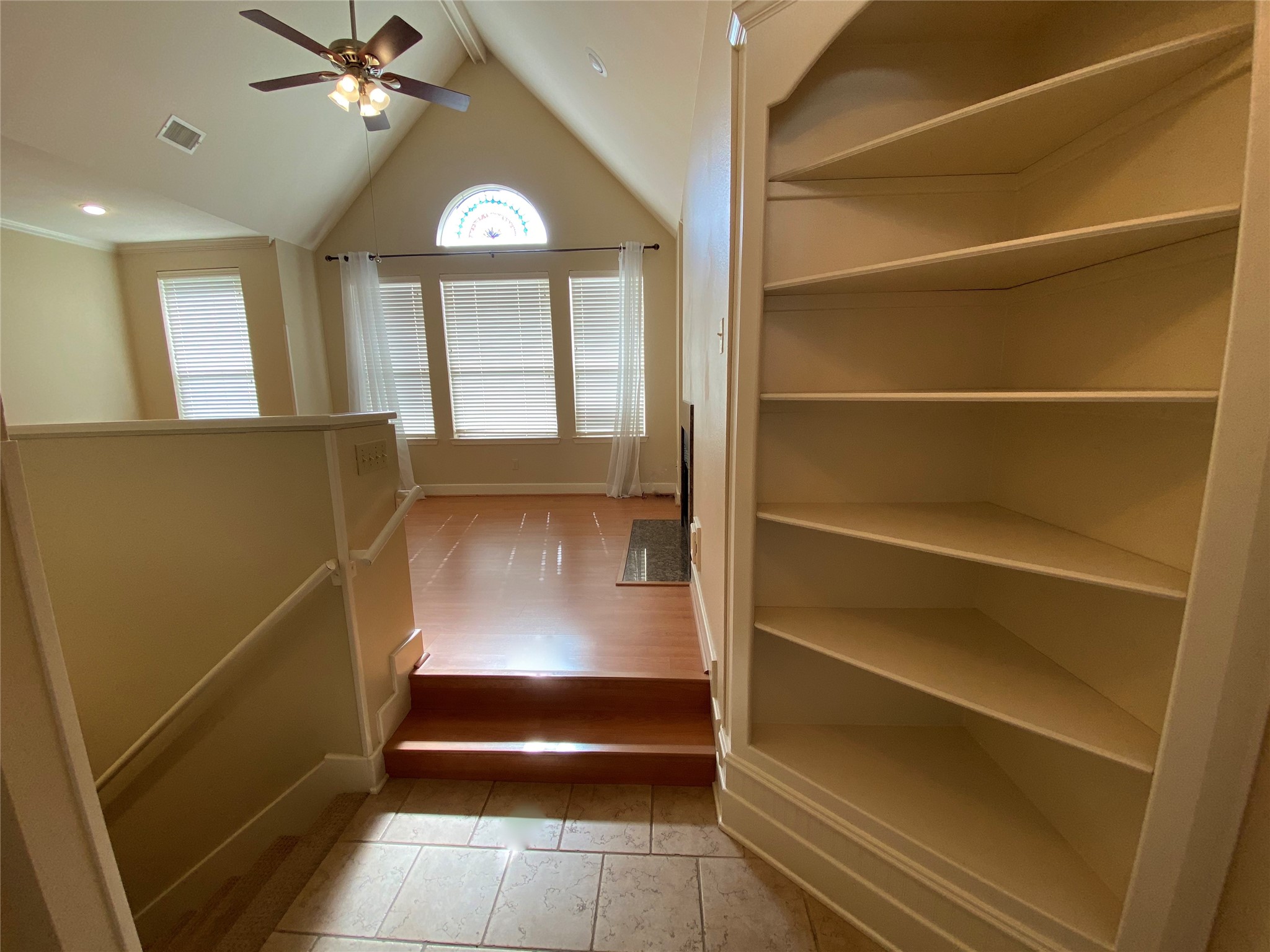 735 Arlington Street, Unit 3 Houston, TX 77007 - Photo 5 of 32 View upon entry with custom shelving on right, stairs down to primary bedroom on the left and around the left corner is the guest bath and bedroom.