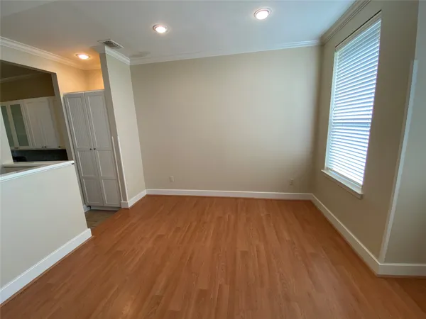 a view of a room with wooden floor and a window