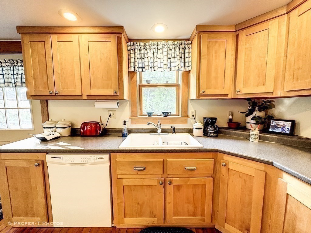23 North Leverett Road Montague, MA 01351 - Photo 15 of 35 a kitchen with stainless steel appliances granite countertop a sink a stove and white cabinets
