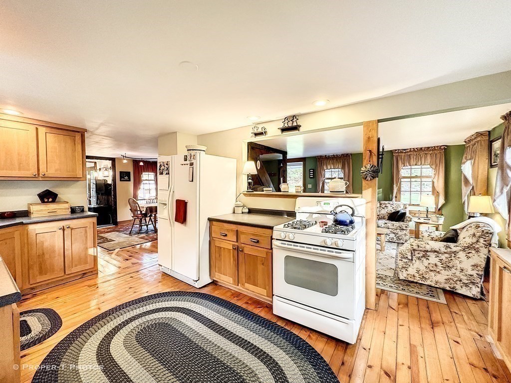 23 North Leverett Road Montague, MA 01351 - Photo 16 of 35 a kitchen with stainless steel appliances kitchen island granite countertop a stove and a sink