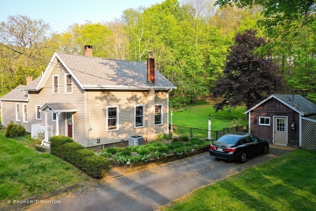 23 North Leverett Road Montague, MA 01351 - Photo 2 of 35 a front view of a house with a garden and trees