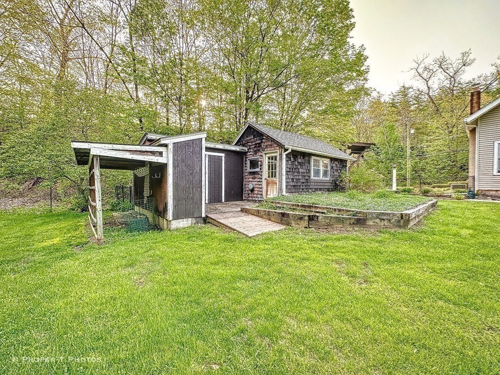 23 North Leverett Road Montague, MA 01351 - Photo 26 of 35 a view of a house with a yard patio and a large tree