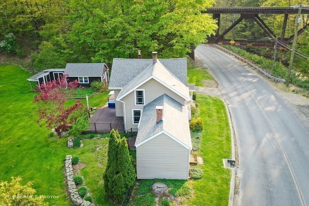 23 North Leverett Road Montague, MA 01351 - Photo 29 of 35 a aerial view of a house with a yard table and chairs