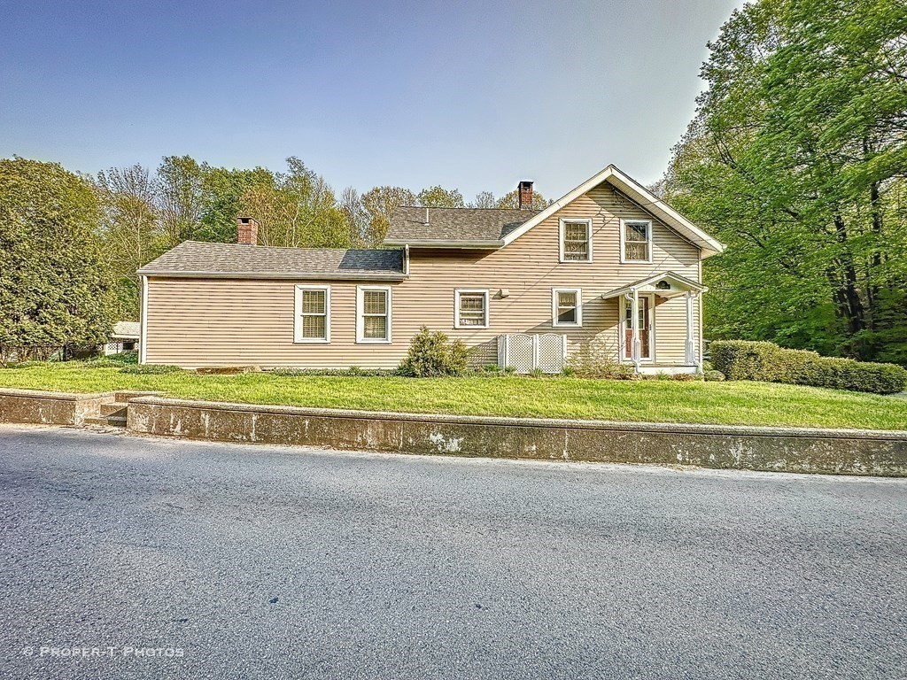 23 North Leverett Road Montague, MA 01351 - Photo 35 of 35 a front view of a house with a yard and garage