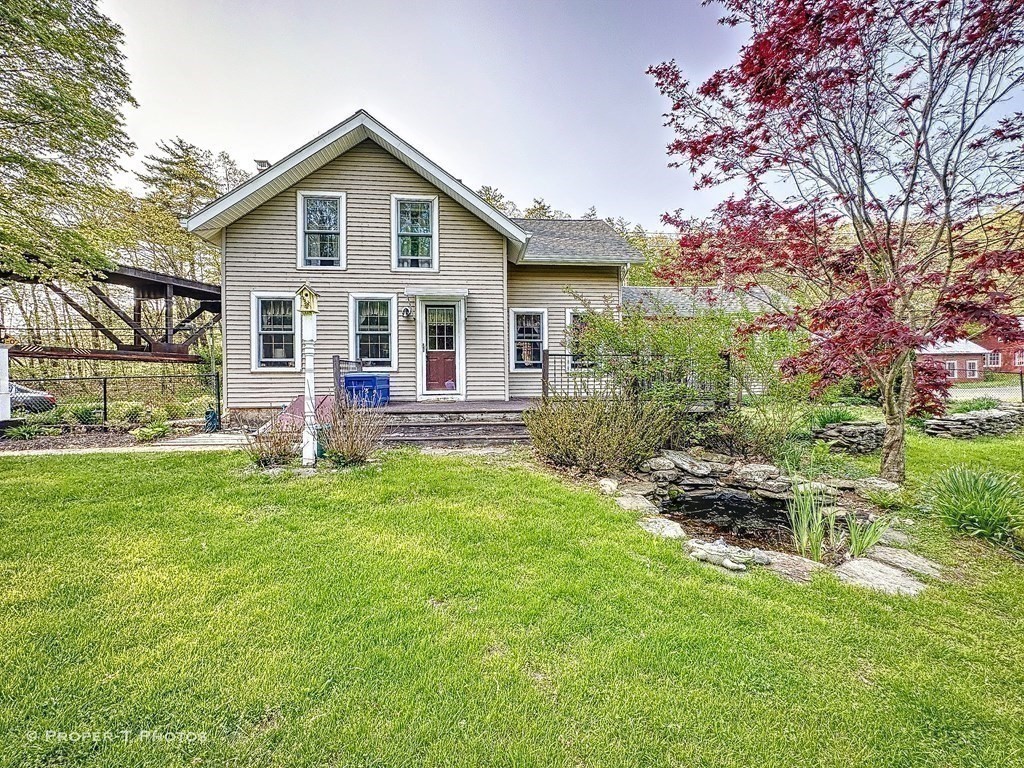 23 North Leverett Road Montague, MA 01351 - Photo 5 of 35 a front view of house with yard and outdoor seating