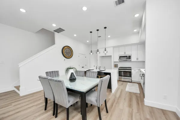 a view of a dining room with furniture and wooden floor
