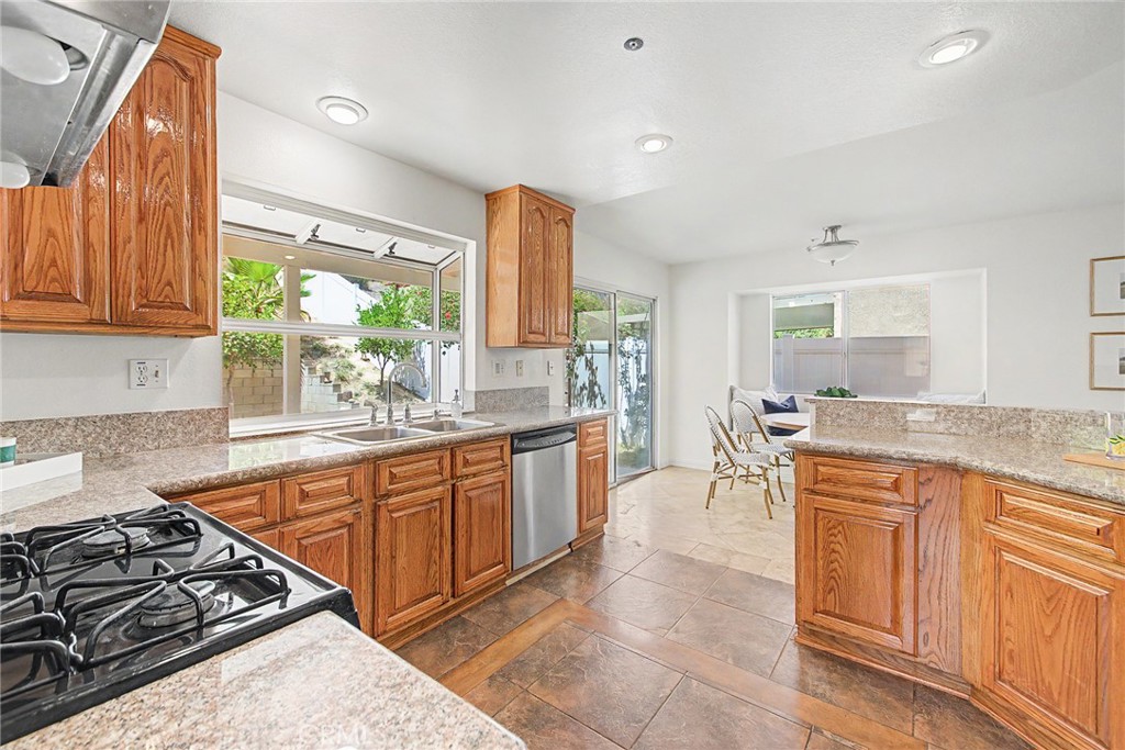 15377 Tobarra Road Fontana, CA 92337 - Photo 9 of 38 Spacious kitchen with a garden window overlooking the backyard
