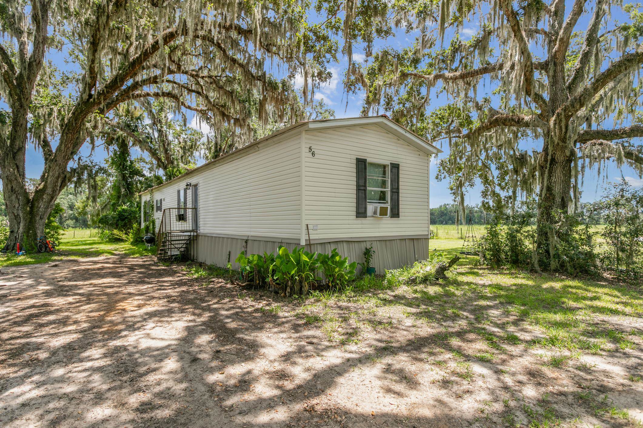 5210 County Road 305 Bunnell, FL 32110 - Photo 55 of 79 a backyard of a house with plants and trees