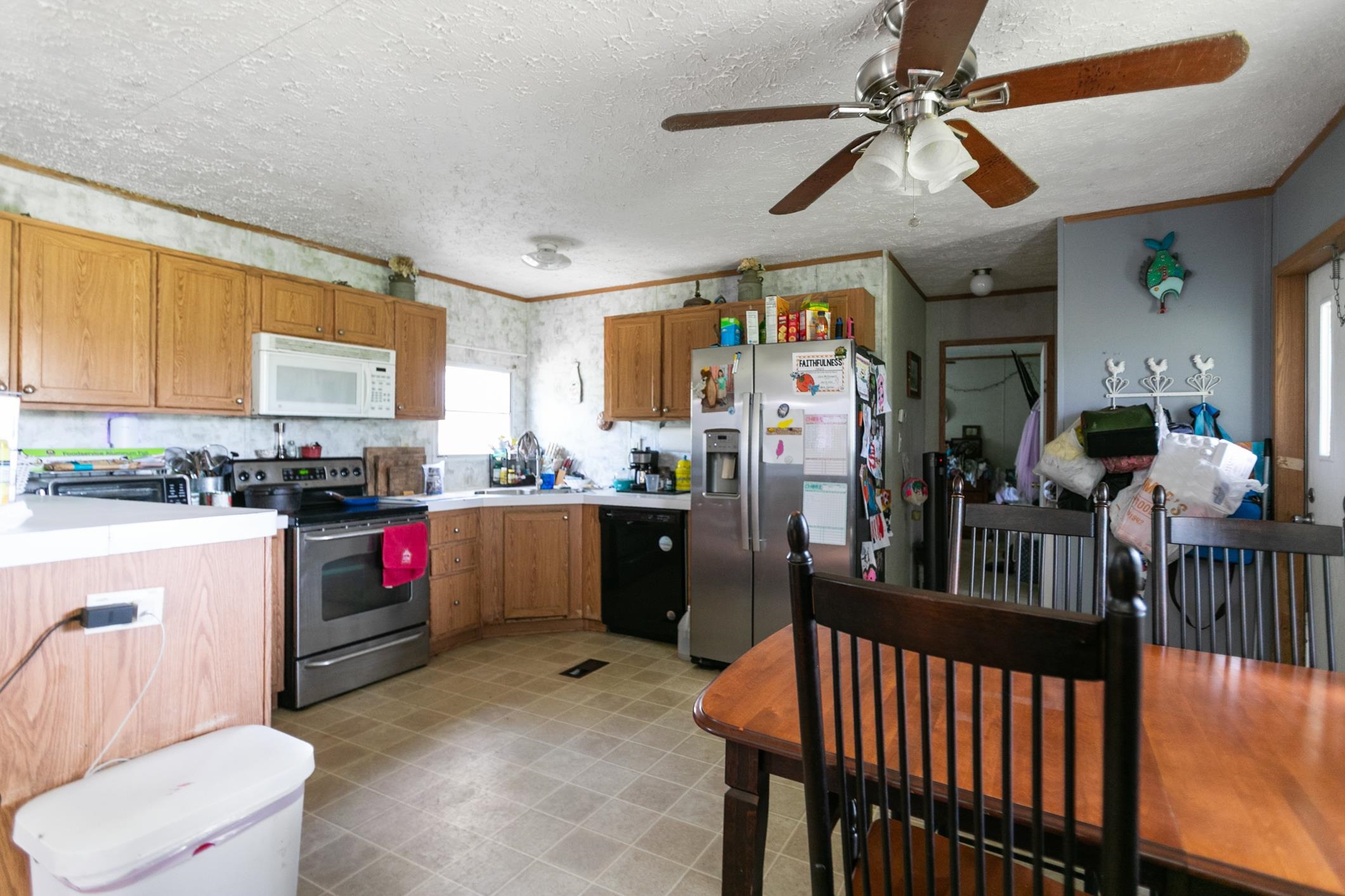 5210 County Road 305 Bunnell, FL 32110 - Photo 62 of 79 a open kitchen with stainless steel appliances kitchen island granite countertop a refrigerator a stove top oven a sink and a dining table with wooden floor