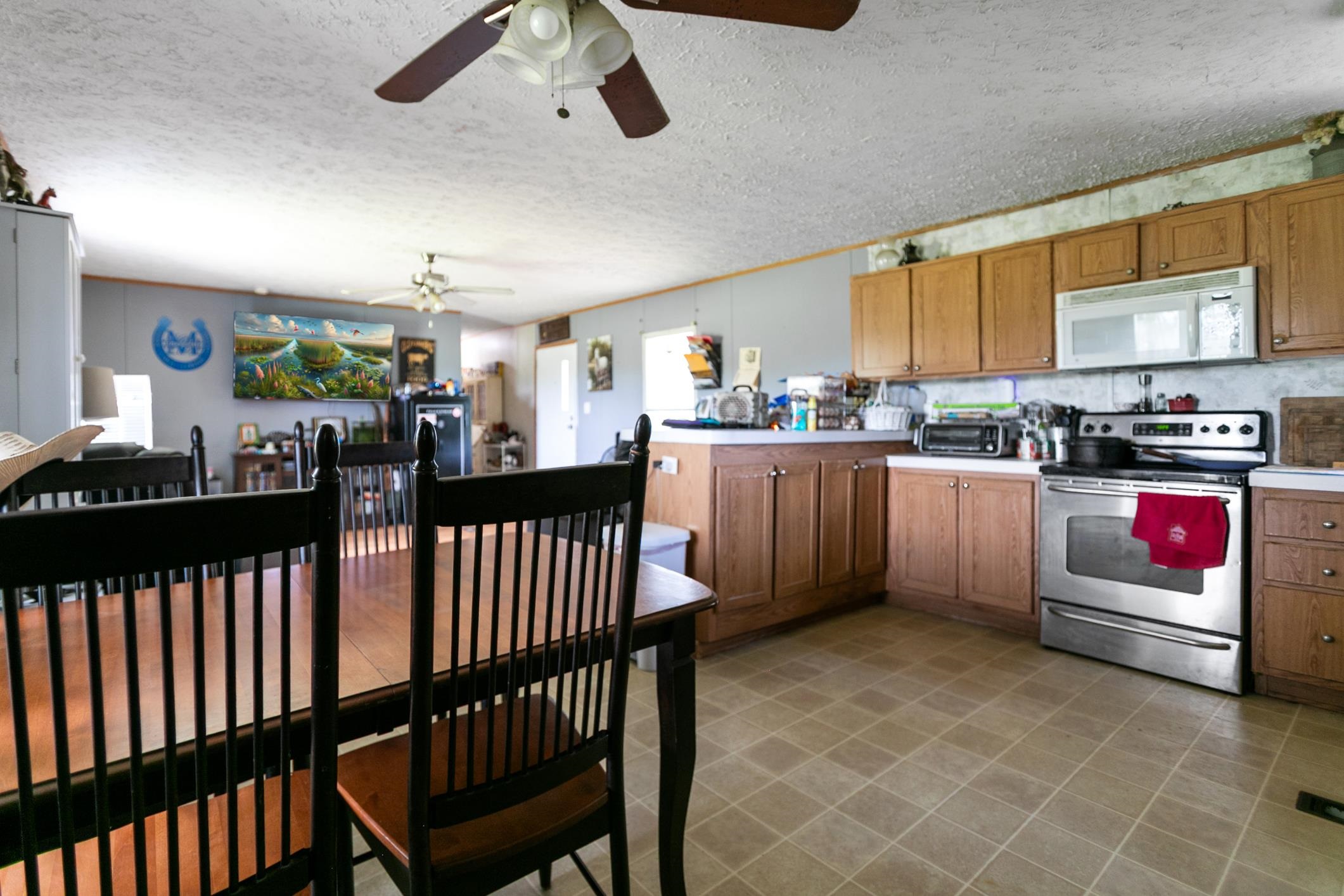 5210 County Road 305 Bunnell, FL 32110 - Photo 64 of 79 a kitchen with stainless steel appliances kitchen island granite countertop a stove a sink and a refrigerator