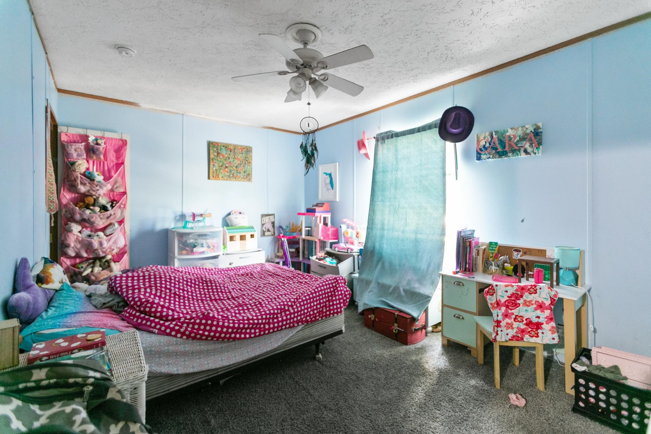 5210 County Road 305 Bunnell, FL 32110 - Photo 67 of 79 a bedroom with a bed and a chandelier