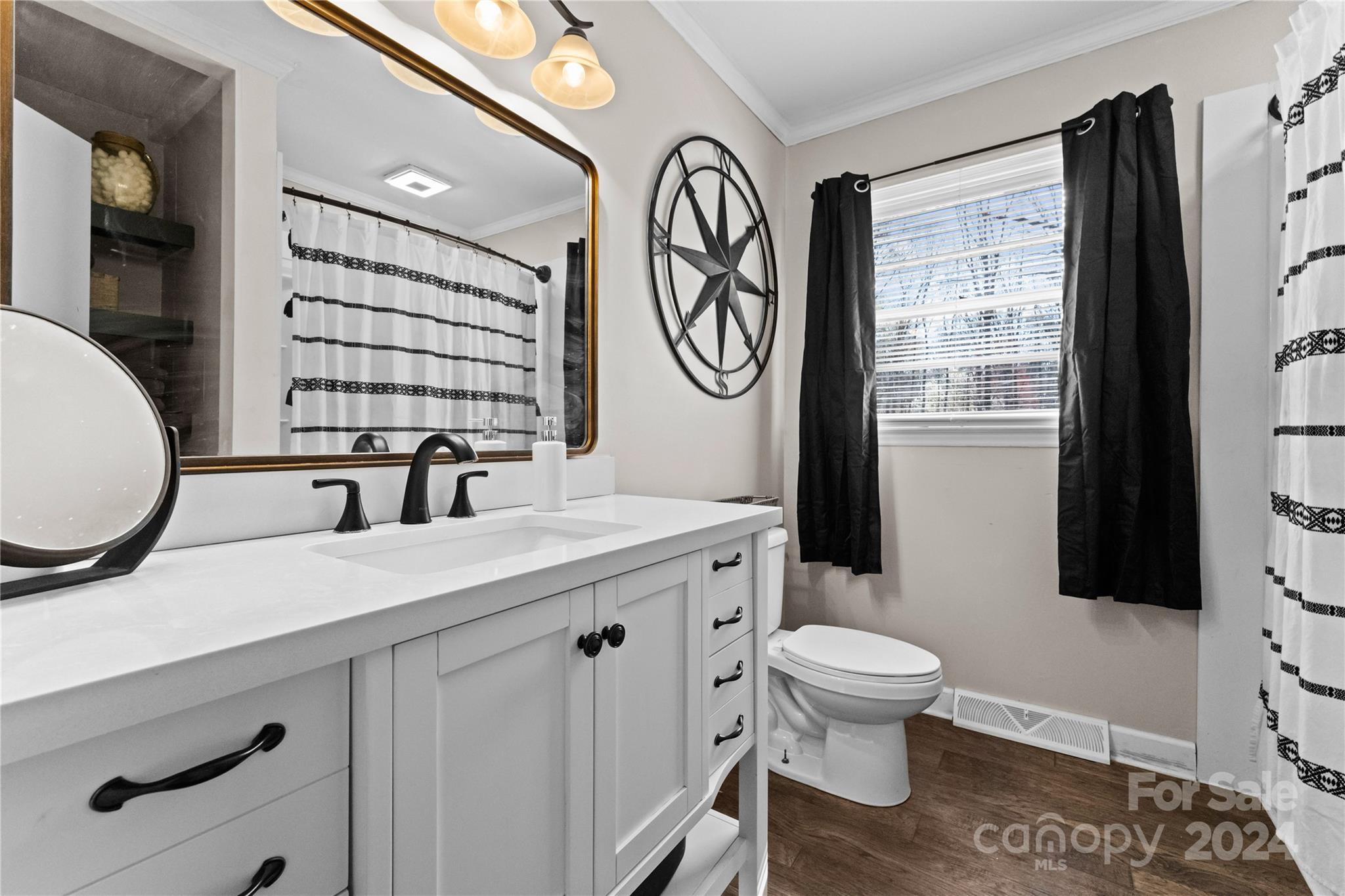 1267 Oak Hill Road Chester, SC 29706 - Photo 15 of 29 a bathroom with a toilet a sink and a mirror