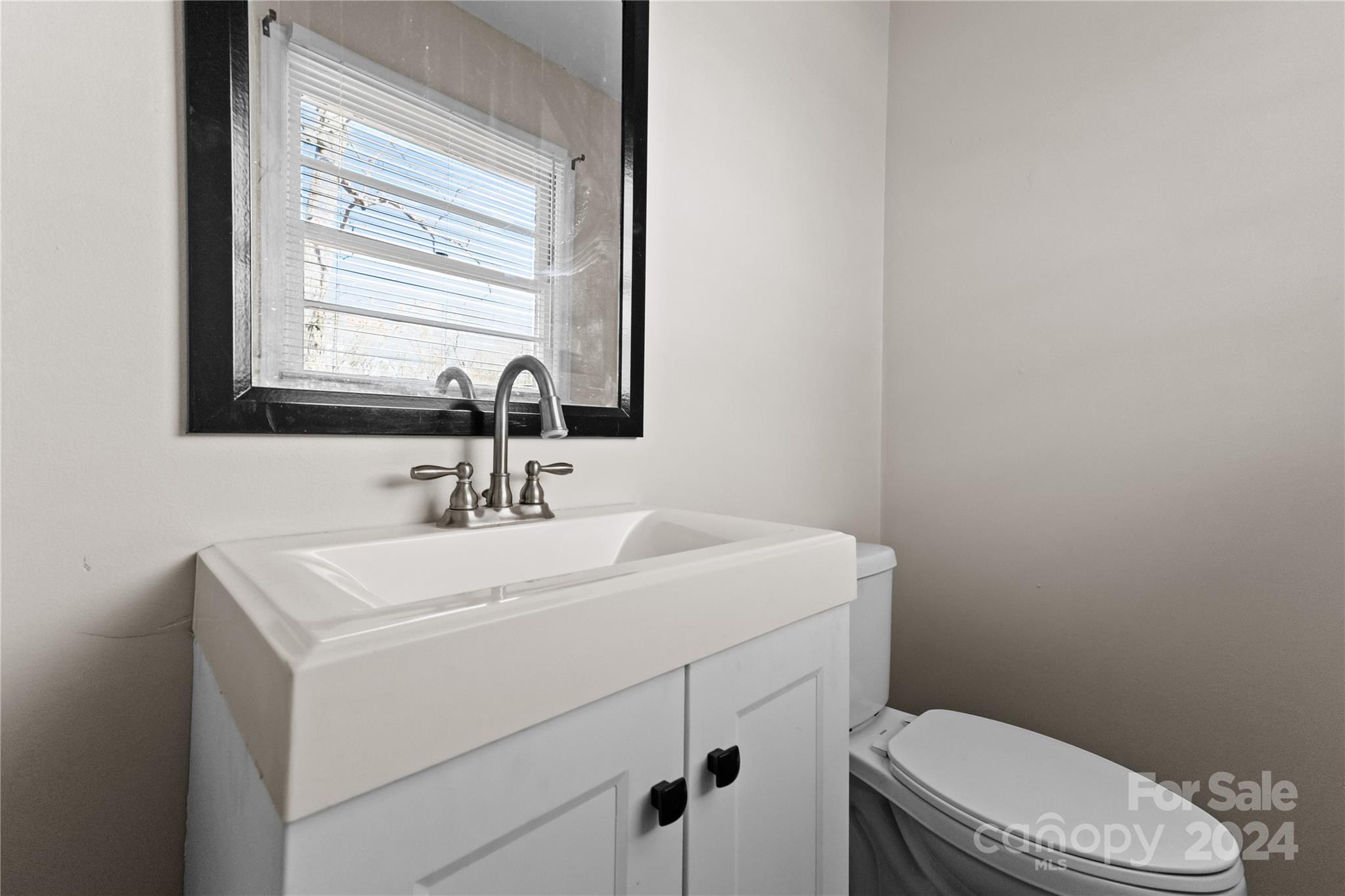 1267 Oak Hill Road Chester, SC 29706 - Photo 17 of 29 a bathroom with a toilet sink and mirror