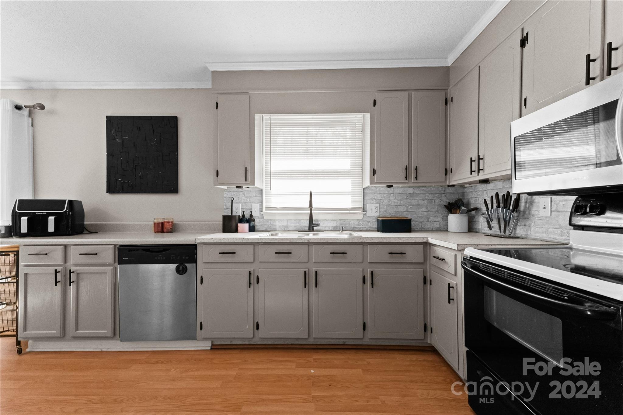 1267 Oak Hill Road Chester, SC 29706 - Photo 8 of 29 a kitchen with stainless steel appliances granite countertop a stove a sink and a microwave