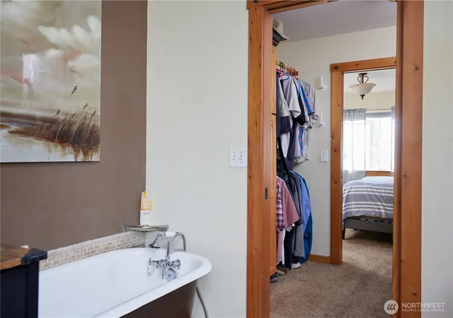 a view of walk in closet with clothes
