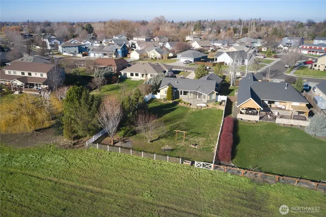 an aerial view of residential houses with outdoor space