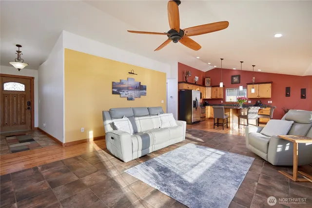 a living room with furniture and a view of kitchen
