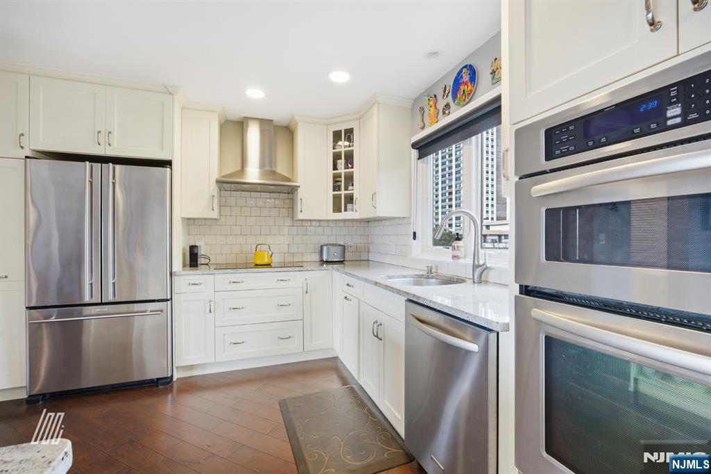 300 Gorge Road, Unit 75 Cliffside Park, NJ 07010 - Photo 8 of 27 a kitchen with stainless steel appliances granite countertop a refrigerator sink and stove