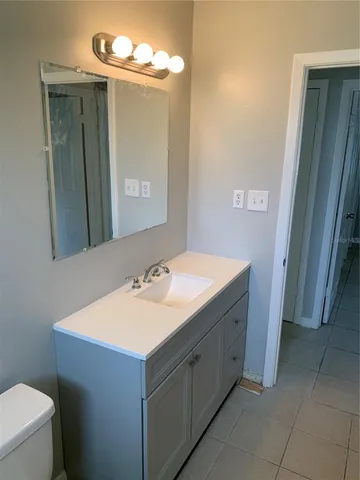 an empty room with a ceiling fan and a window