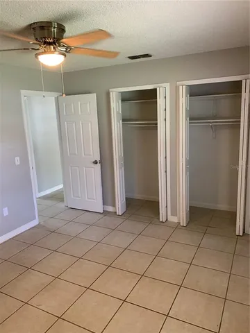 a view of a closet area with wooden floor