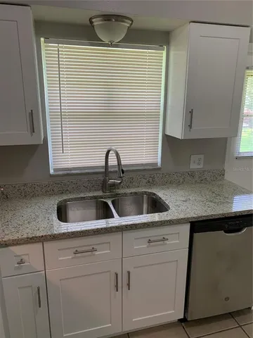 a kitchen with sink and cabinets