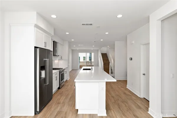 a kitchen with stainless steel appliances granite countertop refrigerator sink and stove