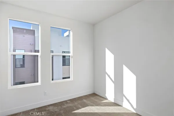a view of an empty room with windows