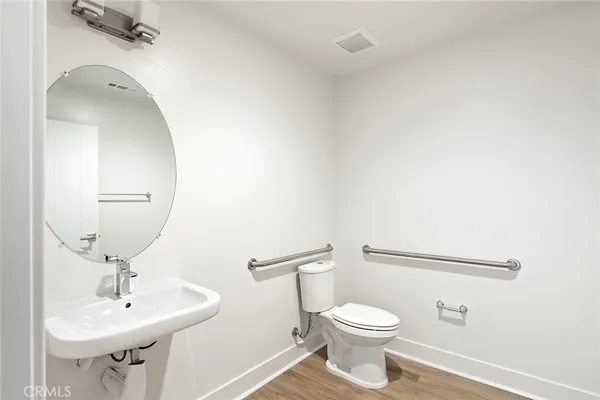 a bathroom with a sink a toilet and mirror