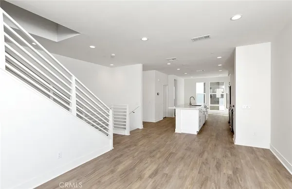 a living room with wooden floor and furniture