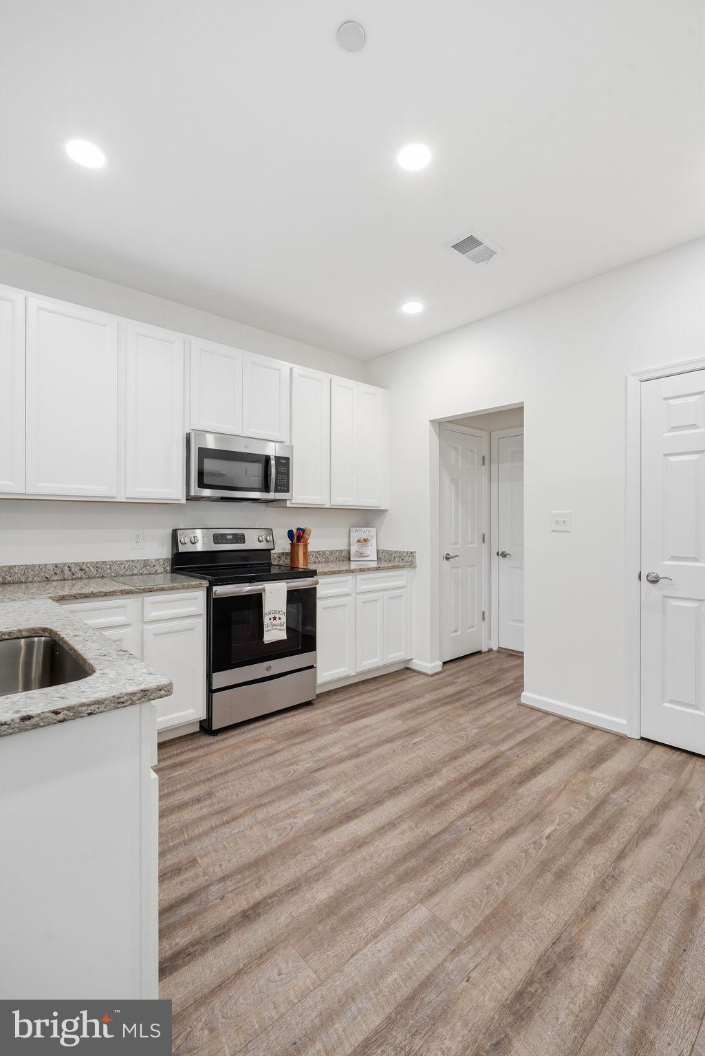 124 Riverside Drive Chester, MD 21619 - Photo 15 of 44 Modern kitchen with sleek finishes.