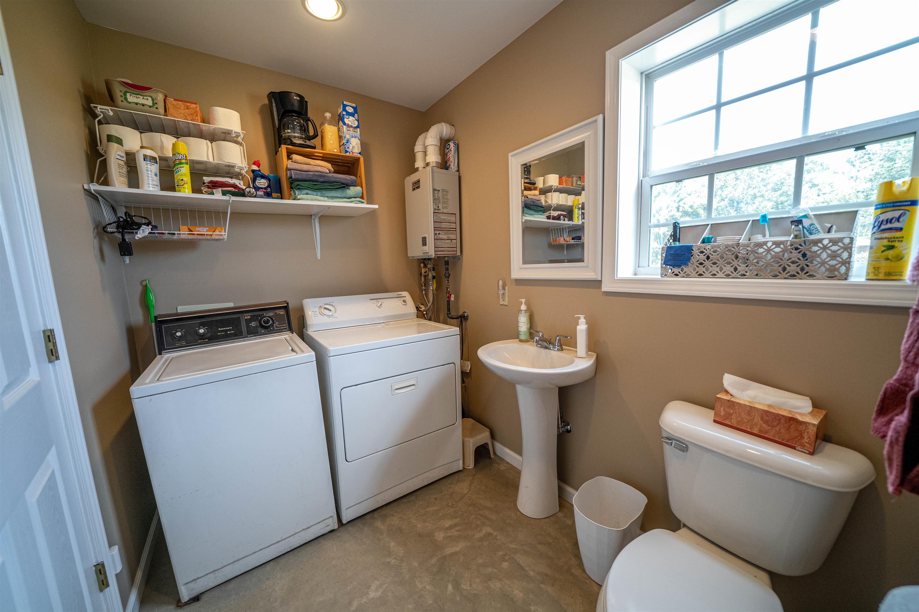1485 Walton Road Bolivar, TN 38008 - Photo 9 of 23 Laundry room featuring washer and dryer and tankless water heater