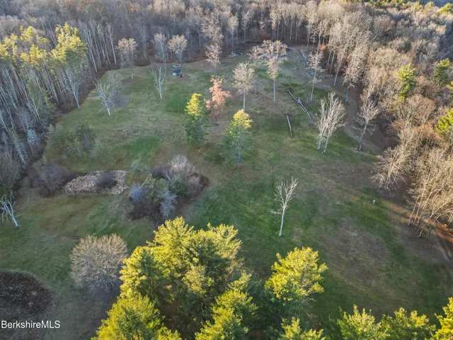 a backyard of a house with a yard with outdoor seating