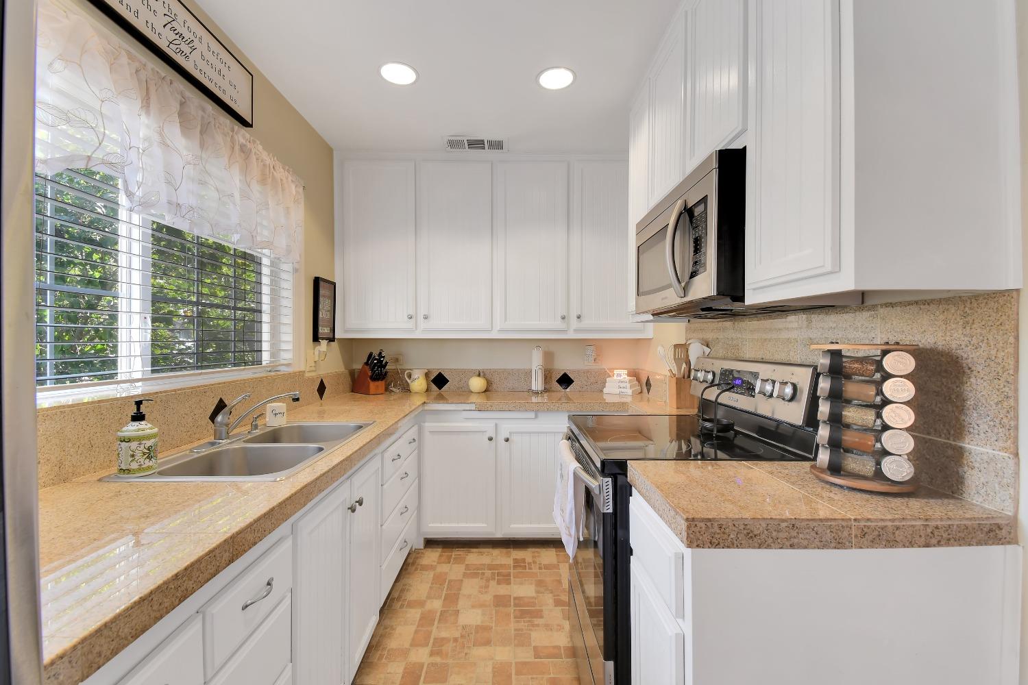 1750 Hazel Street Gridley, CA 95948 - Photo 14 of 20 a kitchen with a sink a stove and cabinets