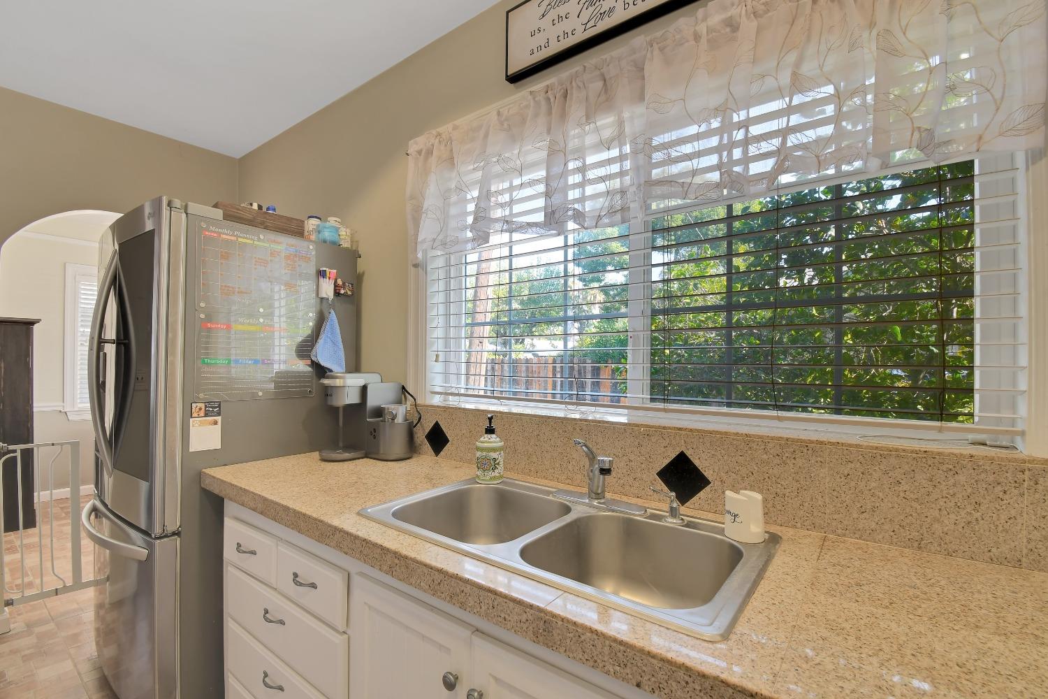 1750 Hazel Street Gridley, CA 95948 - Photo 16 of 20 a bathroom with a granite countertop sink and a large mirror