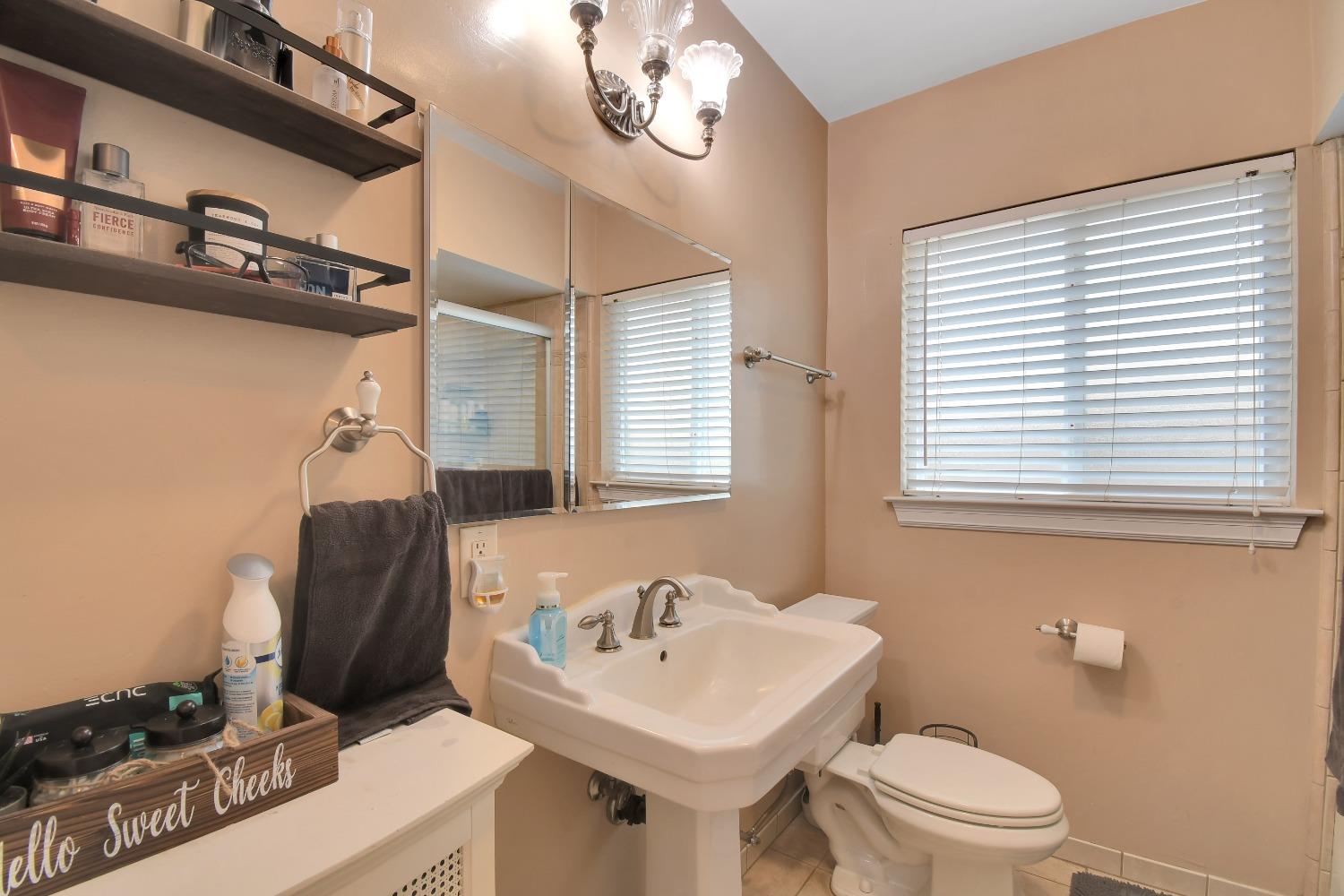 1750 Hazel Street Gridley, CA 95948 - Photo 17 of 20 a bathroom with a sink a toilet and a mirror