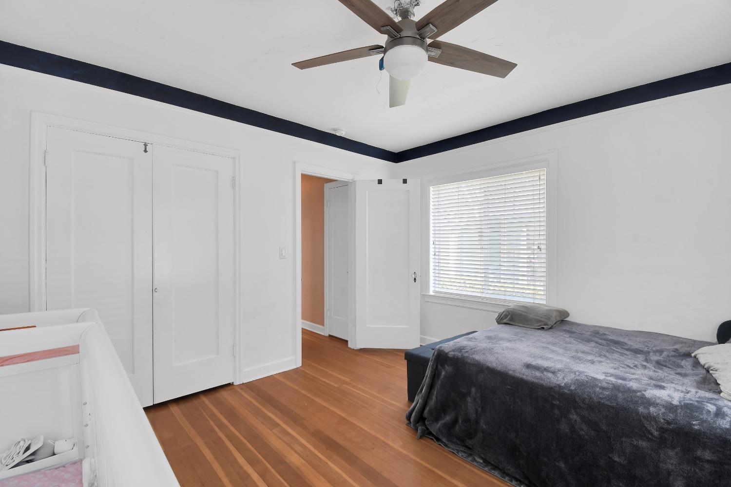 1750 Hazel Street Gridley, CA 95948 - Photo 20 of 20 a bedroom with a large bed and a chandelier