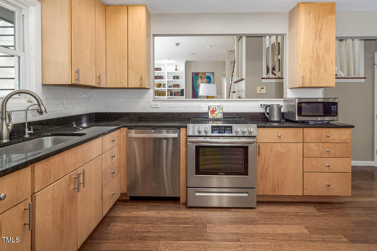 9501 Coachway Chapel Hill, NC 27516 - Photo 11 of 47 a kitchen with stainless steel appliances granite countertop a sink and cabinets