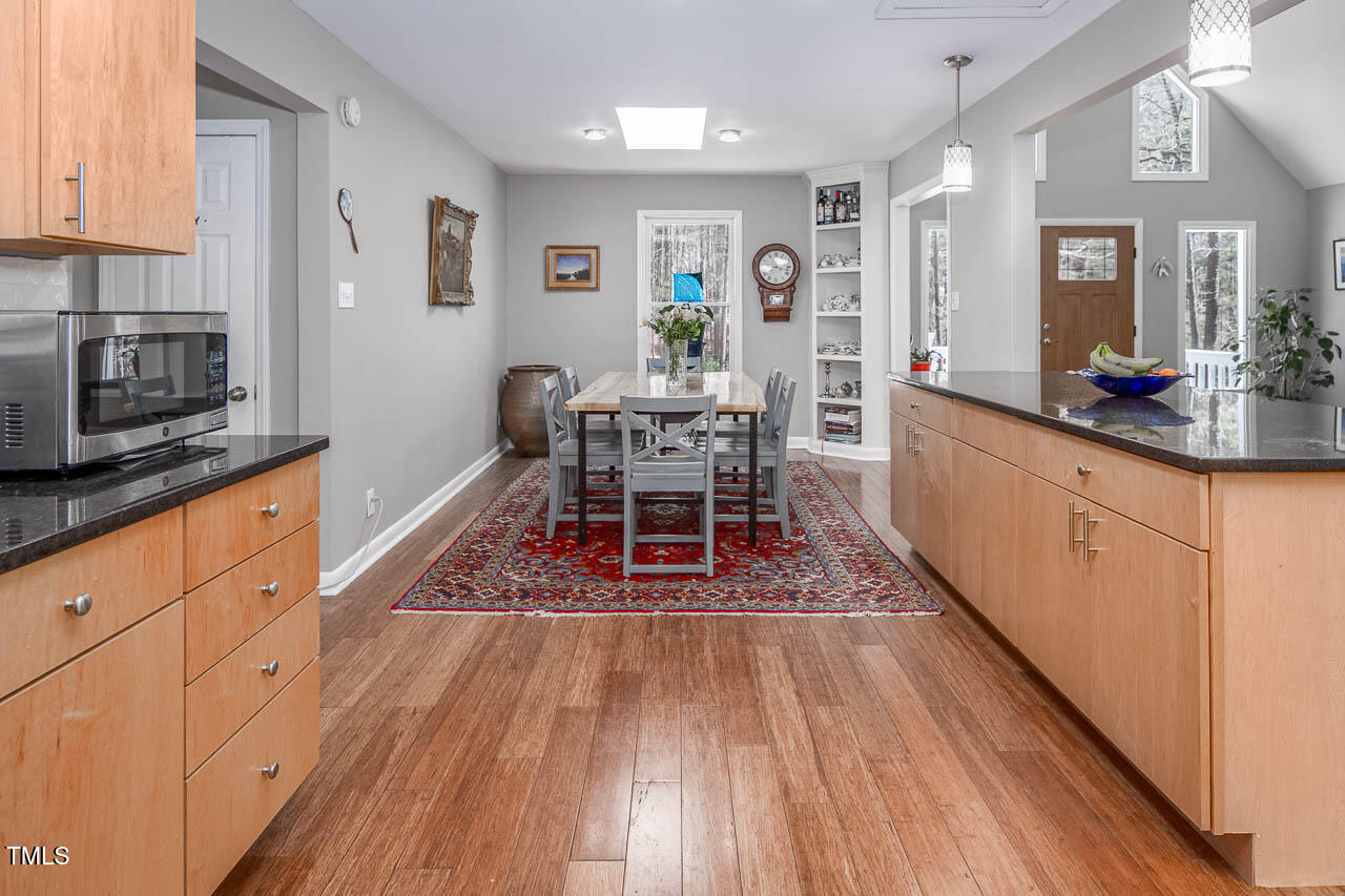 9501 Coachway Chapel Hill, NC 27516 - Photo 12 of 47 a dining hall with wooden floors and stainless steel appliances