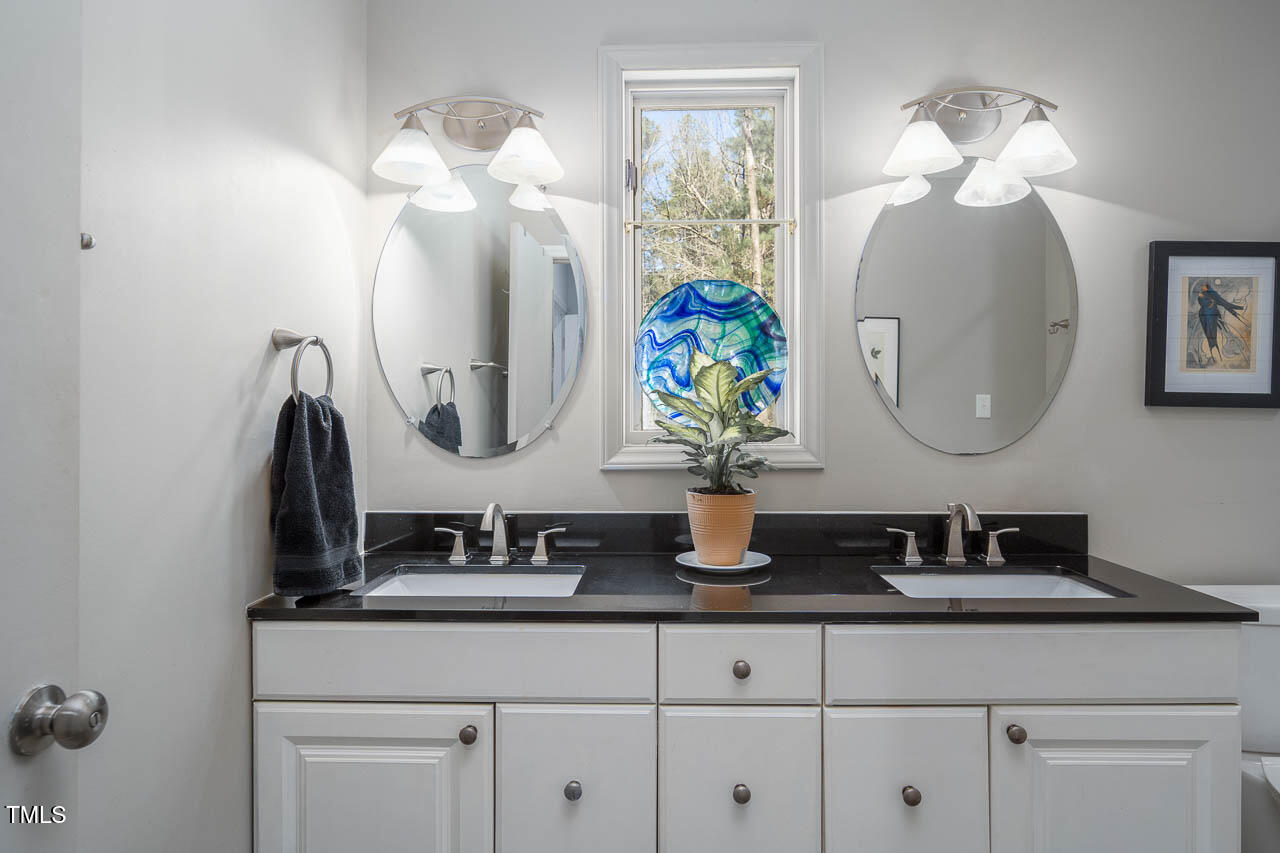 9501 Coachway Chapel Hill, NC 27516 - Photo 17 of 47 a bathroom with a sink a vanity and a mirror