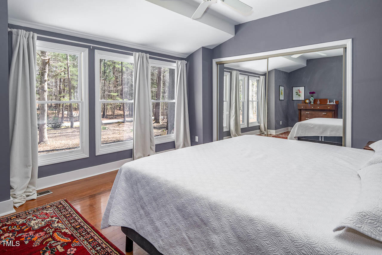 9501 Coachway Chapel Hill, NC 27516 - Photo 19 of 47 a bedroom with a large bed and a large window