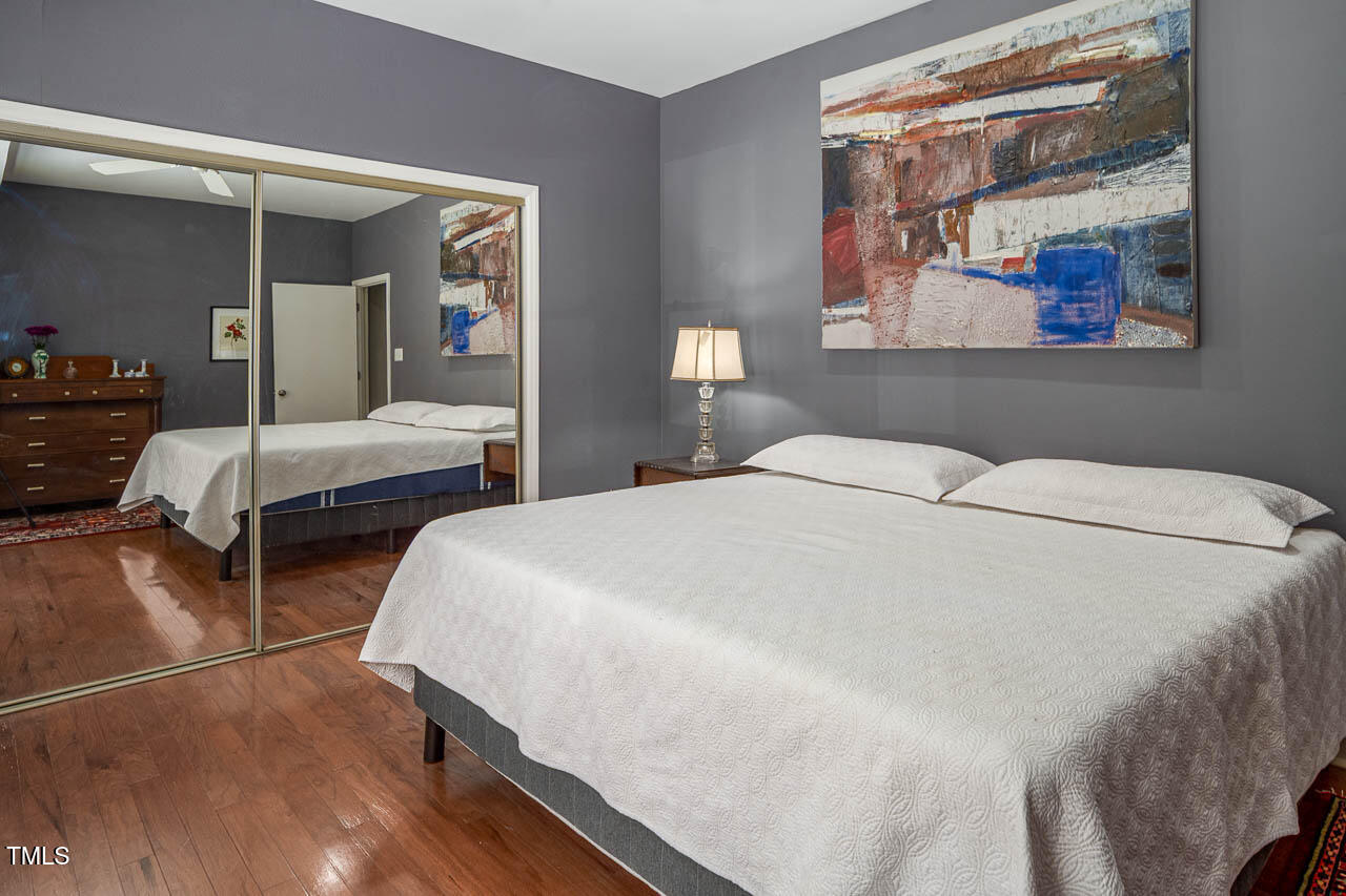 9501 Coachway Chapel Hill, NC 27516 - Photo 20 of 47 a spacious bedroom with two beds and painting on the wall