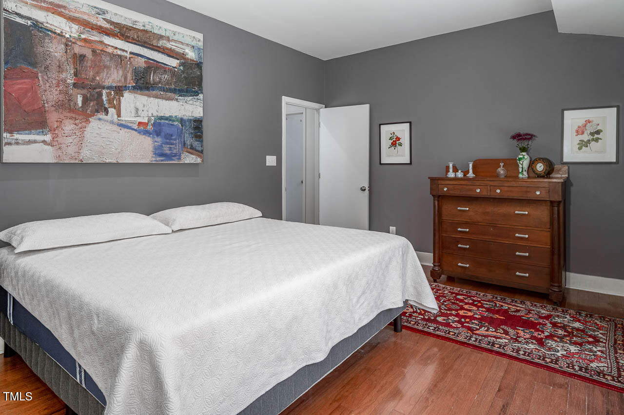 9501 Coachway Chapel Hill, NC 27516 - Photo 21 of 47 a bedroom with a bed and a dresser